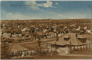 Postcard view of the city of Calgary, Alberta from American Hill, circa 1911, showing a large residential neighbourhood from a slightly elevated standpoint.